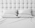 Empty white bed and pillows with luxury headboard