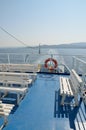 Empty white benches on ferryboat deck