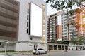 Empty white billboard on building. Modern ad and commercial concept. A large blank billboard on a street wall signboard with room Royalty Free Stock Photo