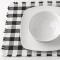 Empty white bowl and plate on napkin Royalty Free Stock Photo