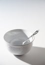 Empty White Bowl with Spoon on a White Background Royalty Free Stock Photo