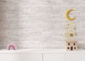 Empty white brick wall. Mock up kids room interior in contemporary style. Close up view. Free, copy space for your