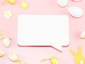 Empty white callout, decorative yellow-white eggs, and a wooden easter bunny on a light pink. Royalty Free Stock Photo