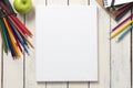 Empty white canvas frame and colorful pencils on whit wooden table Royalty Free Stock Photo
