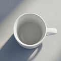 Empty white ceramic mug viewed from above, resting on a light gray textur Royalty Free Stock Photo