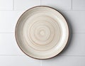 Empty White Ceramic Plate with Brown Rim on White Tile Background Royalty Free Stock Photo