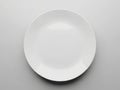 Empty white ceramic plate on gray background Royalty Free Stock Photo