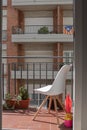 Empty white chair on a balcony on a urban location Royalty Free Stock Photo