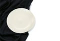 Empty white circle modern ceramic plate with silk tablecloth texture on white background , Top view