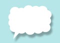 Empty white cloud paper speech bubble shape against light blue background Royalty Free Stock Photo