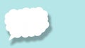 Empty white cloud paper speech bubble shape against light blue background Royalty Free Stock Photo