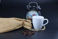 Empty white coffee cup with coffee bean and bag on black color background. Royalty Free Stock Photo