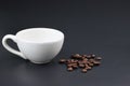 Empty white coffee cup with coffee bean on black color background. Royalty Free Stock Photo