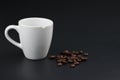 Empty white coffee cup with coffee bean on black color background. Royalty Free Stock Photo
