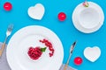 Empty white colorful plate and wineberry for table setting on blue table backgroung top view Royalty Free Stock Photo
