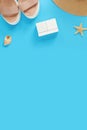 Empty white cubes on a blue background with summer accessories, top view