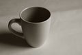Empty white cup on a light background. Cup with place for text. Copyspace Royalty Free Stock Photo