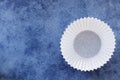 Empty White Cupcake Case over Blue Background