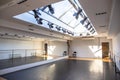 Empty white dance studio or hall for activities or yoga room with mirror wall and windows in celling