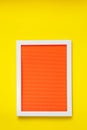 Empty  white frame on bright orange red texture hanging on  yellow wall Royalty Free Stock Photo