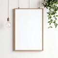 Empty White Frame Mockup with Hanging Lightbulb and Plant Royalty Free Stock Photo