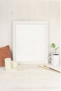 Empty white frame mockup with small branch of succulent zamioculcas in a vintage vase mug on old rustic table Royalty Free Stock Photo