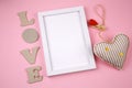 Empty white wooden frame and heart