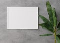 Empty, white, horizontal picture frame on concrete wall. Mock up interior in minimalist, contemporary style. Free, copy Royalty Free Stock Photo