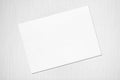 Empty white horizontal rectangle poster mockup lying diagonally on grey concrete background Royalty Free Stock Photo