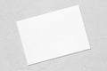 Empty white horizontal rectangle poster mockup lying diagonally on grey concrete background Royalty Free Stock Photo
