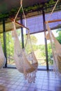 Empty white knitting rope swings hanging by the window in cafe Royalty Free Stock Photo