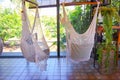 Empty white knitting rope swings hanging by the window in cafe Royalty Free Stock Photo