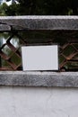 An empty white laminated sign attached to a bridge