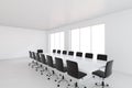 Empty white large meeting room with leather chairs and a table. 3d rendering Royalty Free Stock Photo