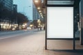 Empty white lightbox mockup at a public transportation stop in the city at dusk.