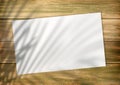 Empty white list on an old style wooden empty background with plam leaf shadow