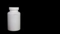 Empty white medical bottle on a black background Royalty Free Stock Photo