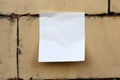 Empty white memo note pad stuck to dirty wall Royalty Free Stock Photo