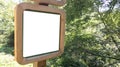 Empty white mockup information blank sign board in the park forest Royalty Free Stock Photo
