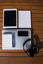 Empty white notepad with mobile phone, laptop, headphones and tablet Royalty Free Stock Photo