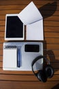 Empty white notepad with mobile phone, laptop, headphones and tablet Royalty Free Stock Photo