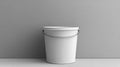Empty White Paint Bucket with Metallic Handle Resting Against a Gray Wall Royalty Free Stock Photo