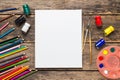 Empty white paper and colorful pencils on wooden table Royalty Free Stock Photo