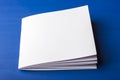 Empty white paper for notes, notebook, diary, booklet, organizer on a blue background. Royalty Free Stock Photo