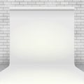 Empty white paper photo studio backdrop in room with white brick wall Royalty Free Stock Photo