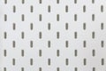 Empty white pegboard or holes wall for hanging tool texture background