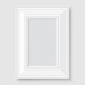 Empty white photo frame with shadow on gray wall. Royalty Free Stock Photo