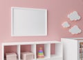 Empty white picture frame on pink wall in modern child room. Mock up interior in scandinavian style. Free, copy space Royalty Free Stock Photo