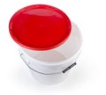Empty white plastic bucket with partly removed red lid Royalty Free Stock Photo