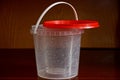 Empty white plastic bucket with a red lid Royalty Free Stock Photo